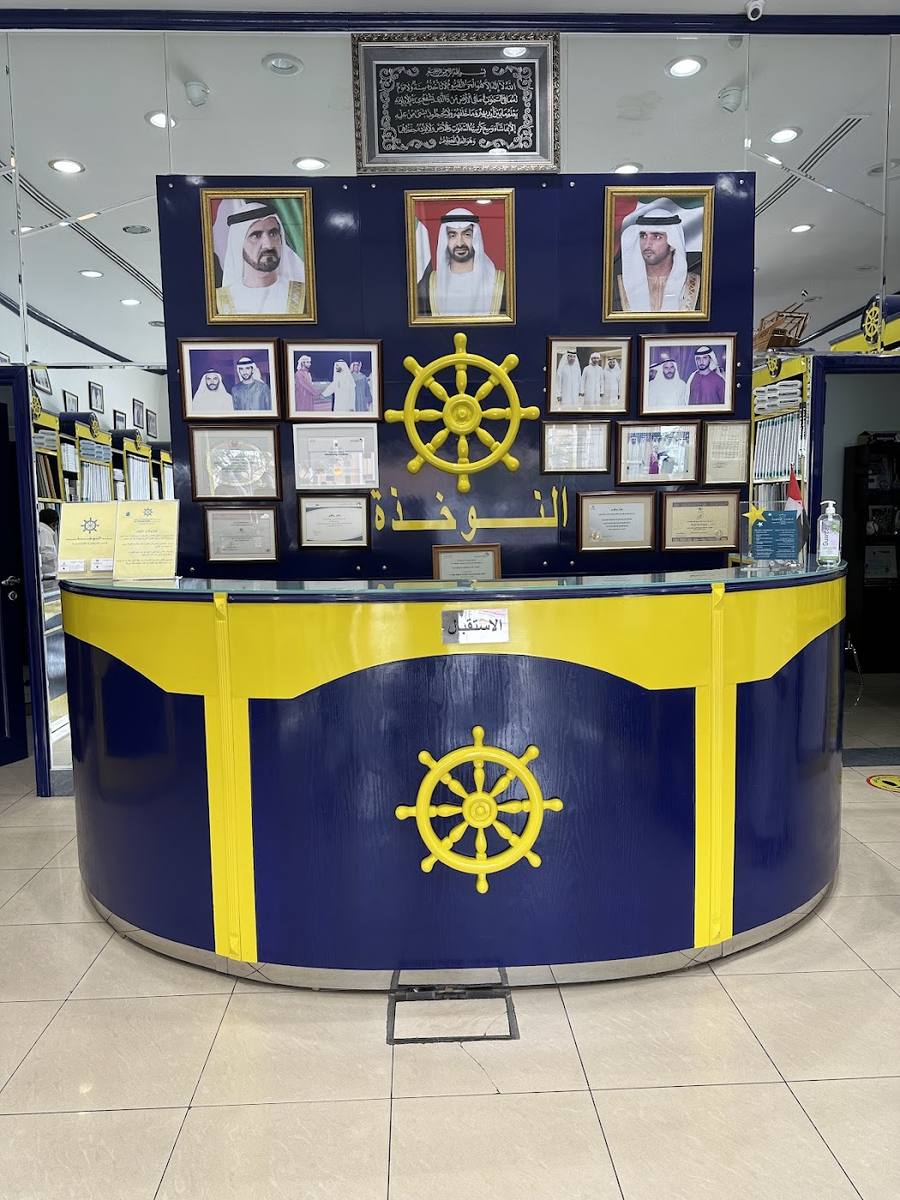 The navy counter with the gold ship's wheel and shelves of folded cloth behind it