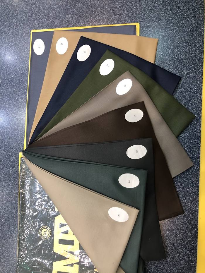 Shelves of kandura cloth in light shades